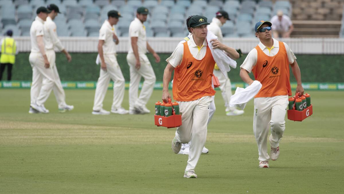 Tom Vane-Tempest and Dan Leerdam ran the water for the Australian team at Manuka Oval last summer. A new role today. Picture: Sitthixay Ditthavong
