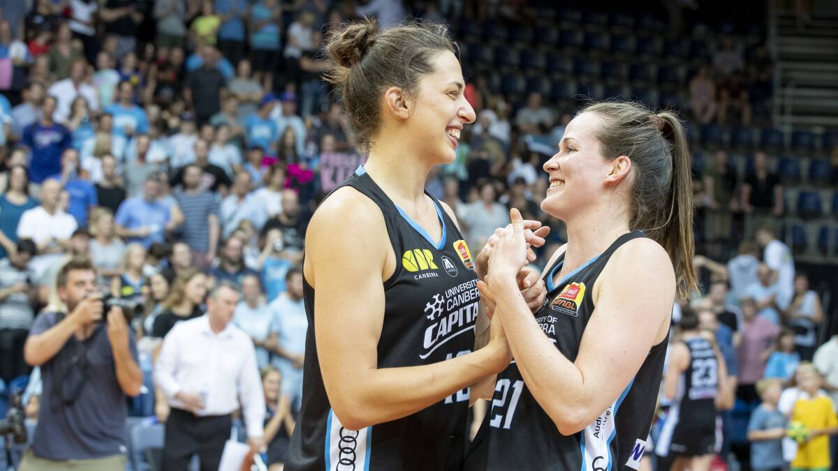 The Canberra Capitals' Marianna Tolo and Keely Froling share a laugh after their 88-67 win over the Adelaide Lightning at AIS Arena. Photo: Sitthixay Ditthavong