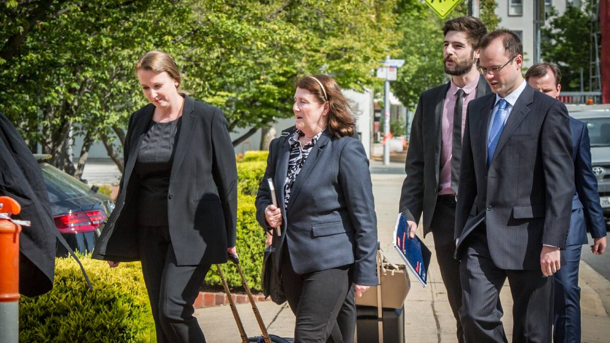 Melissa Beowulf (centre) and her sons Thorsten Halley Beowulf (right, wearing glasses) and Bjorn Toren Beowulf (far right behind Thorsten) arrive at the ACT courts with their legal team. Picture: Karleen Minney