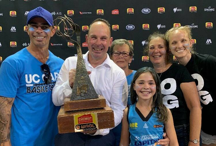 Canberra Capitals coach Paul Goriss celebrates the ultimate WNBL success with his family.