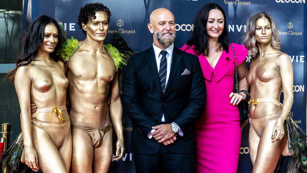 Geocon managing director Nick Georgalis and marketing director Melanie Hindson with gold-painted models on the red carpet at the Envie launch. Picture: Supplied