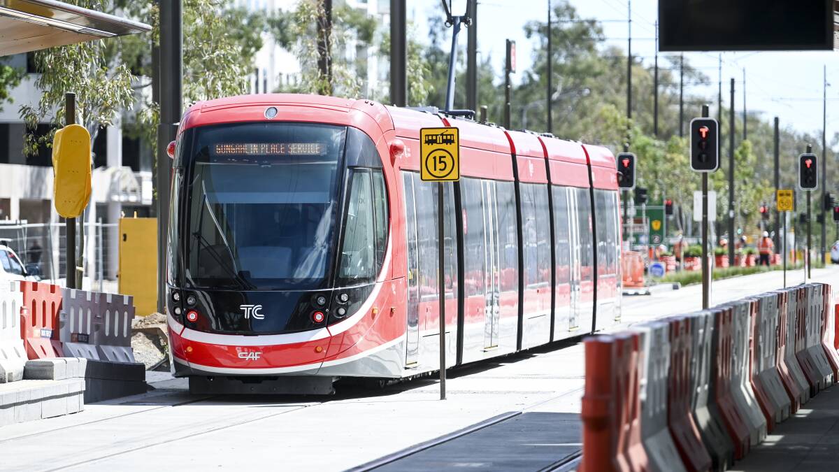 A tram takes to Northbourne Avenue in March, under budget and nearly on time.
