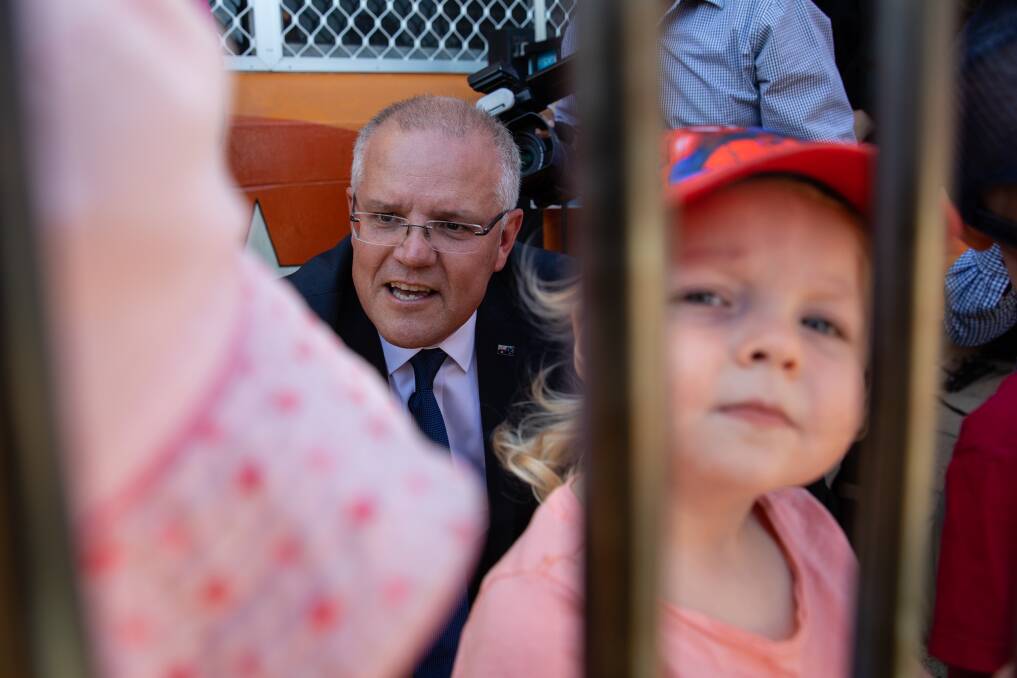 Prime Minister Scott Morrison meets children from a nearby school following a press conference in Perthin March. Picture: AAP Image/Richard Wainwright