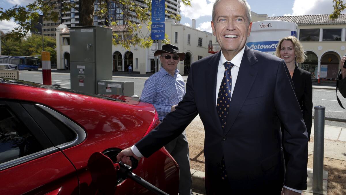 Opposition Leader Bill Shorten poses with an electric car at a charging station during the launch of Labor's Climate Change Action Plan in Canberra on April 1, 2019. Photo: Alex Ellinghausen