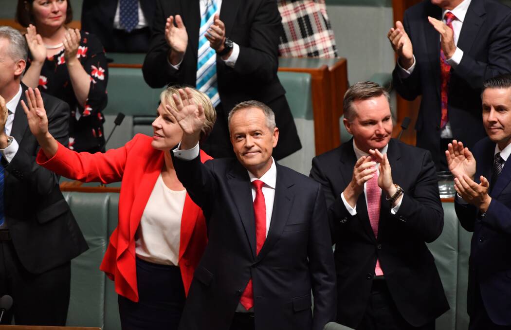 Opposition Leader Bill Shorten (centre) waves after delivering the 2019-20 federal budget reply speech at Parliament House on Thursday. Photo: AAP Image/Mick Tsikas