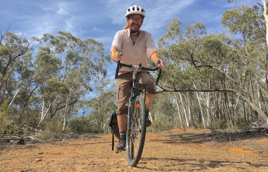 Archaeologist Steve Skitmore rides along part of the Old Weetangera Road near Calvary Hospital. Photo: Tim the Yowie Man