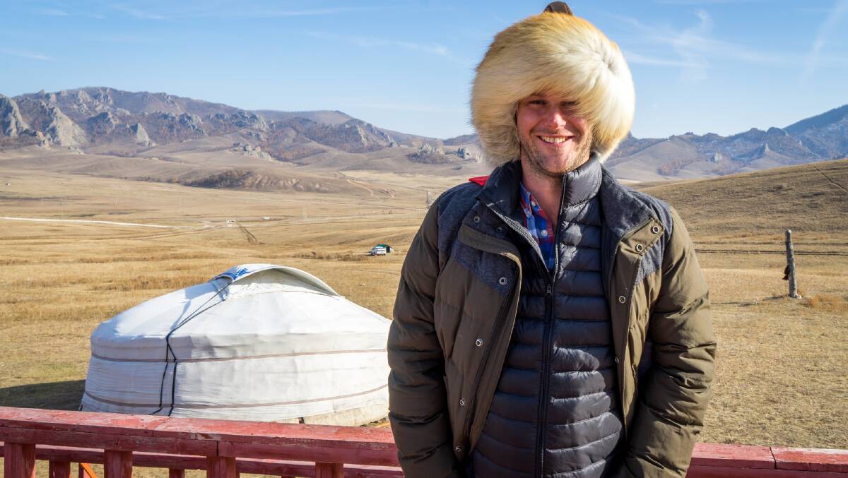 Doing as the locals do: Michael, wearing a traditional fur hat, stayed in a yurt while travelling in Mongolia.