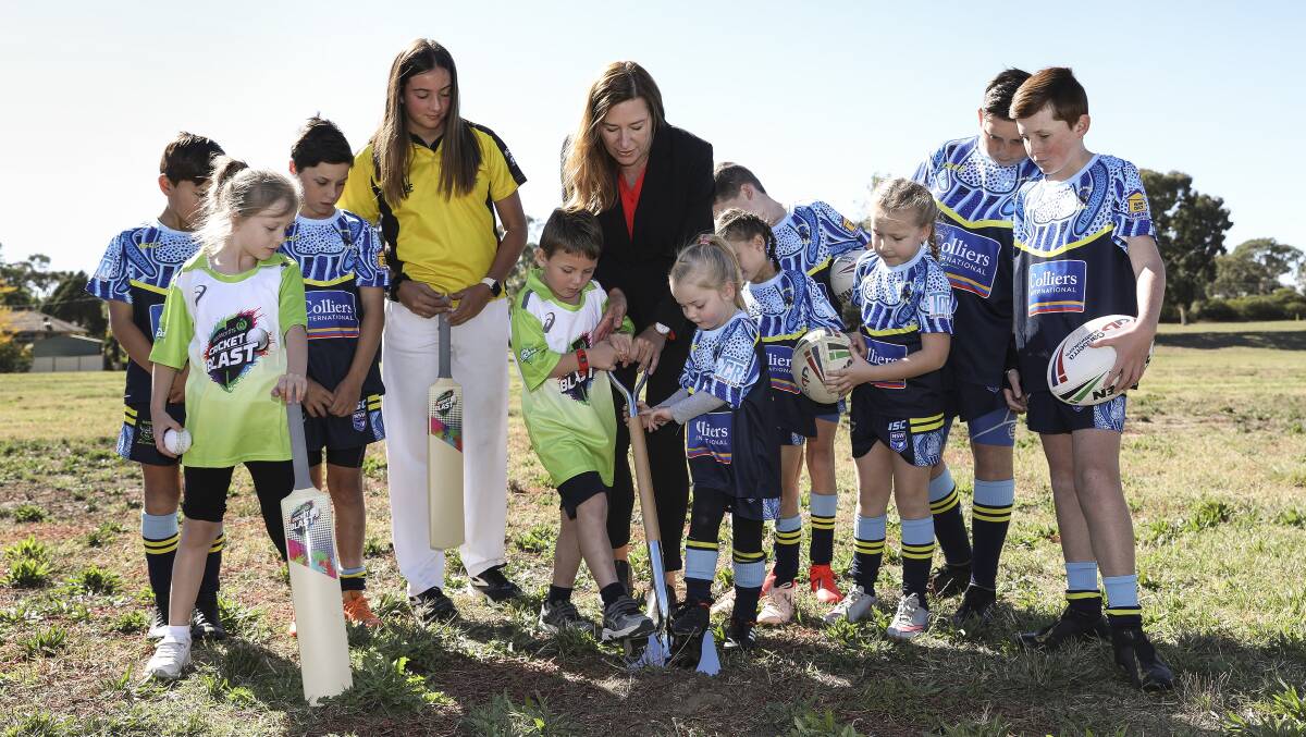 ACT Sports Minister Yvette Berry turns the first sod on Higgins Oval. She wants to formalise the community work Canberra's elite sporting teams do.