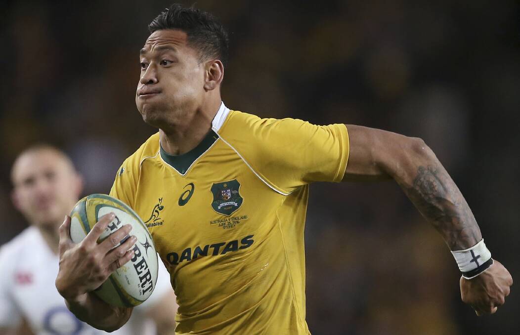 In this 2016, photo, Australian rugby union player Israel Folau, wearing tape on his wrist adorned with a cross, runs toward the try line. Photo: AP