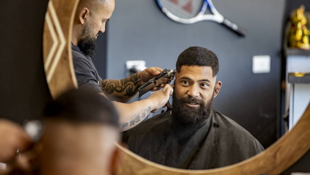Brumbies prop Scott Sio gets a trim from Casper Aniversario on Thursday. Photo: Sitthixay Ditthavong