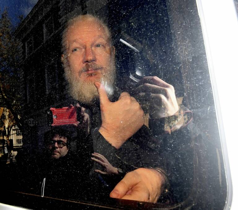 Julian Assange gestures as he arrives at Westminster Magistrates' Court in London, after the WikiLeaks founder was arrested by officers from the Metropolitan Police and taken into custody Thursday, April 11. Photo: AP