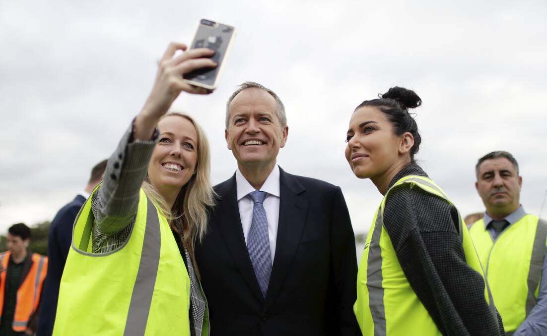 Opposition Leader Bill Shorten poses for a selfie while campaigning at Sydney Markets. Photo: Alex Ellinghausen