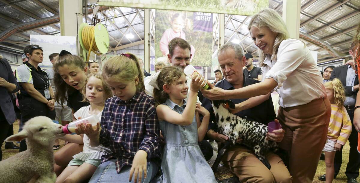 Bill and Chloe Shorten and children Rupert and Clementine with Labor candidate for Reid Sam Crosby and his family during their visit to the Royal Easter Show in Sydney on Saturday. Photo: Alex Ellinghausen