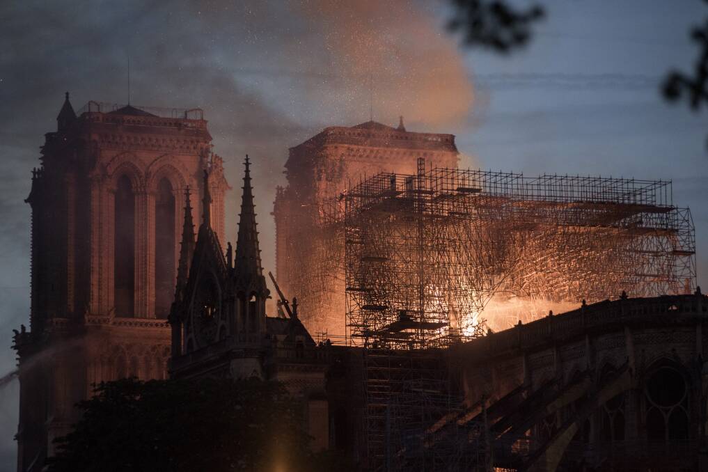 Flames and smoke rise from a fire at Notre-Dame Cathedral in Paris, France, on Monday. Photo: Martin Barzilai/Bloomberg