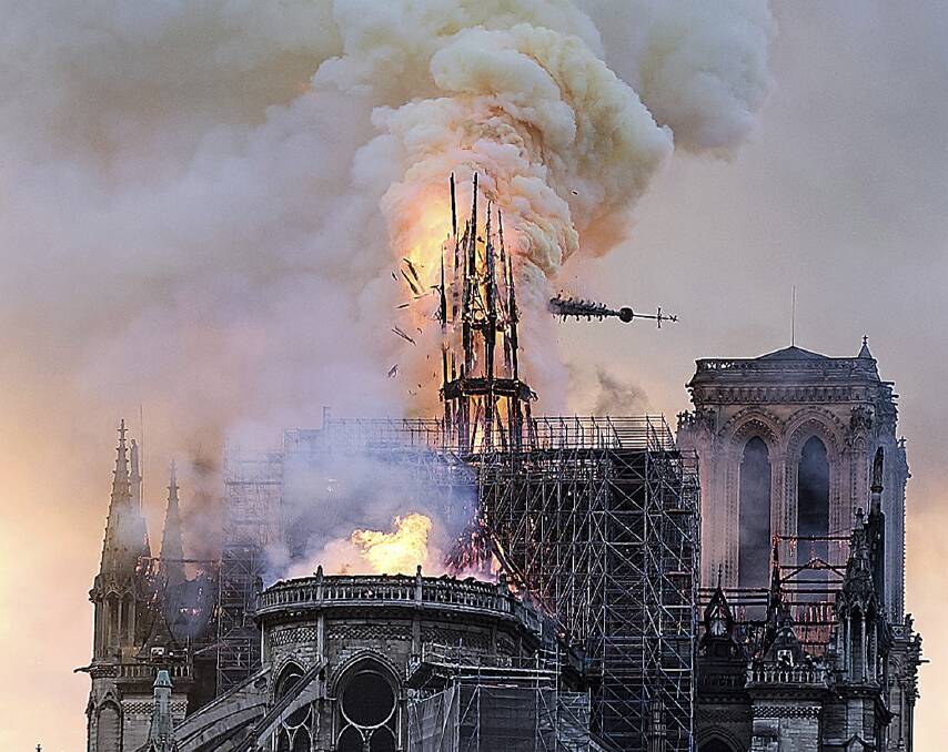 Flames and smoke rise as the spire on Notre Dame cathedral collapses in Paris. Photo: AP.