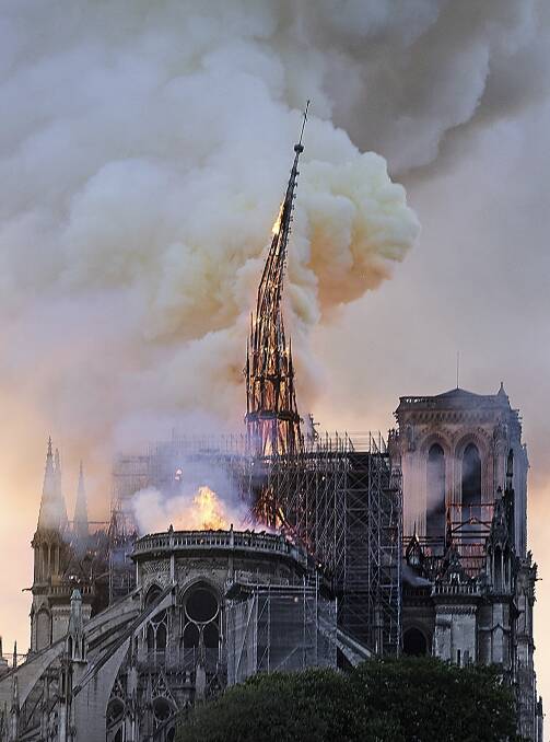 Flames and smoke rise as the spire on Notre-Dame cathedral collapses in Paris on Monday. Photo: AP Photo/Diana Ayanna.