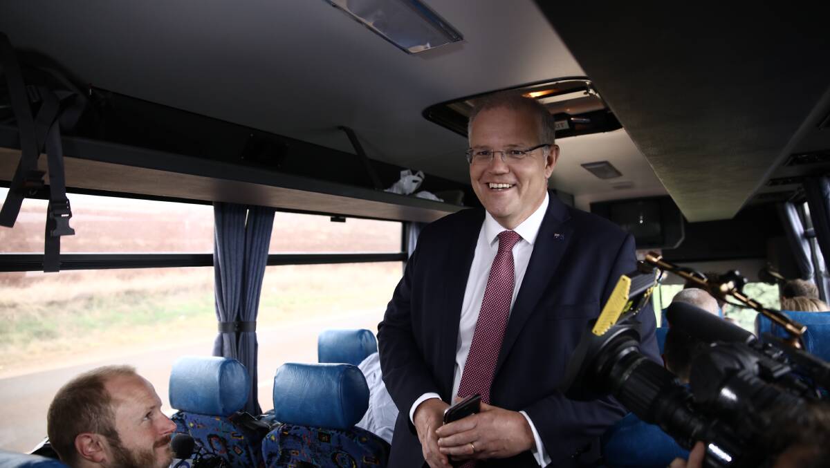 Prime Minister Scott Morrison gets on the media bus in Tasmania. Photo: Dominic Lorrimer