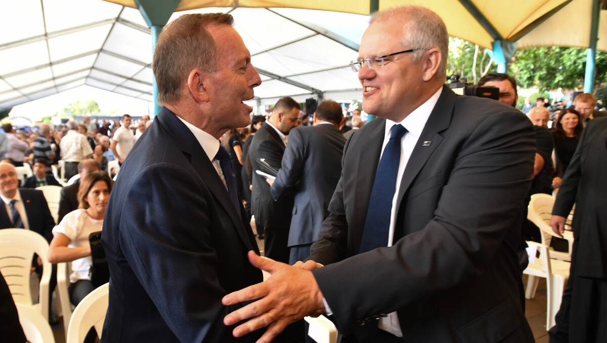 Former prime minister Tony Abbott and Prime Minister Scott Morrison at Good Friday Easter services at St Charbel's Catholic Maronite Church in Sydney. Photo: AAP