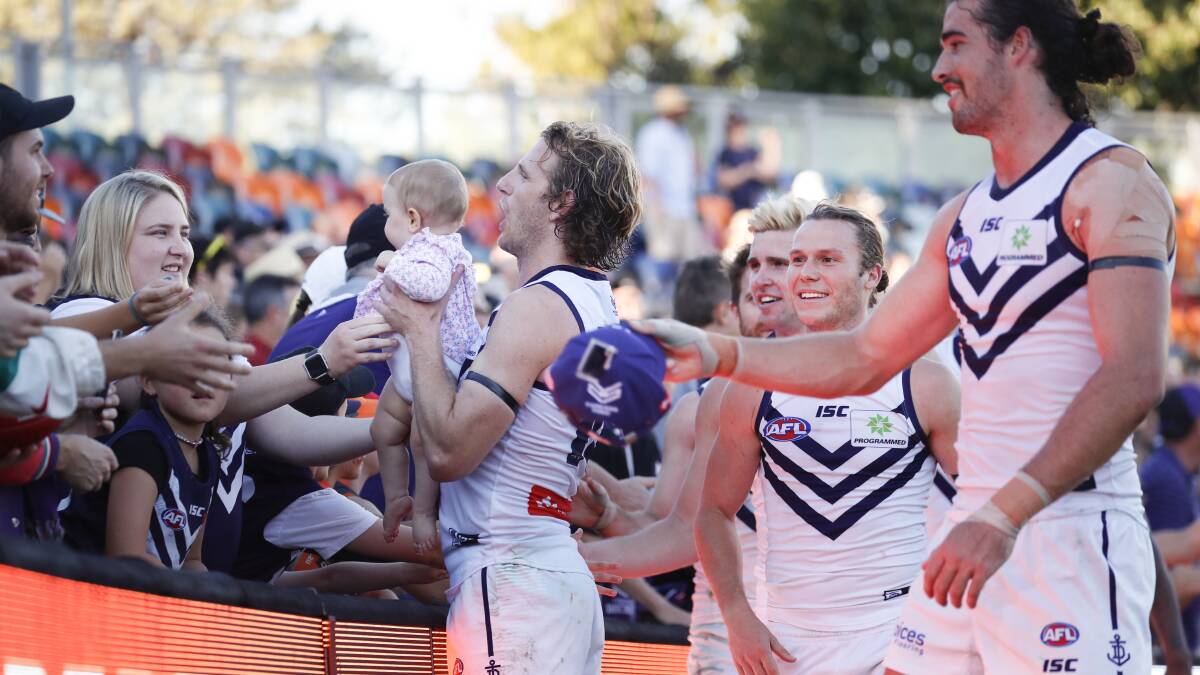 Fremantle players celebrate their 106-82 win over the GWS Giants. Photo: Sitthixay Ditthavong
