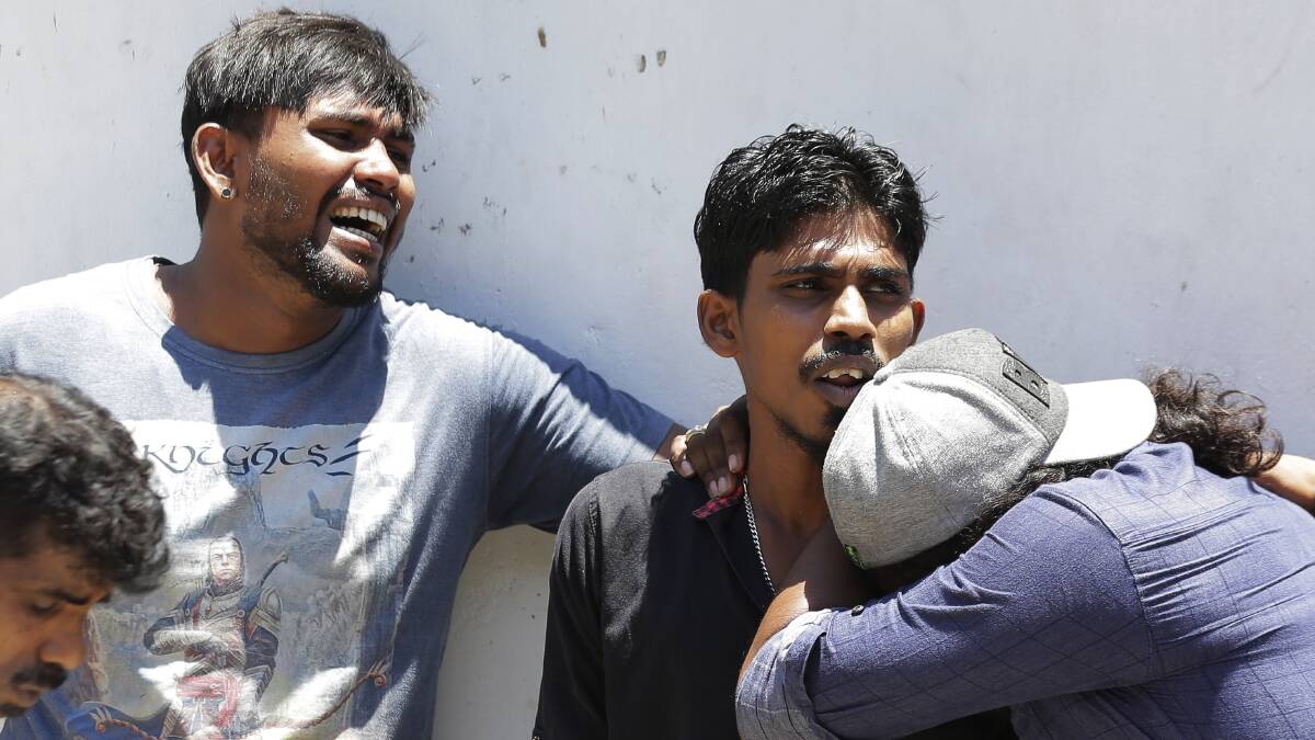Relatives of people killed in the blasts mourn as they wait outside mortuary of a hospital in Colombo, Sri Lanka. Photo: AP