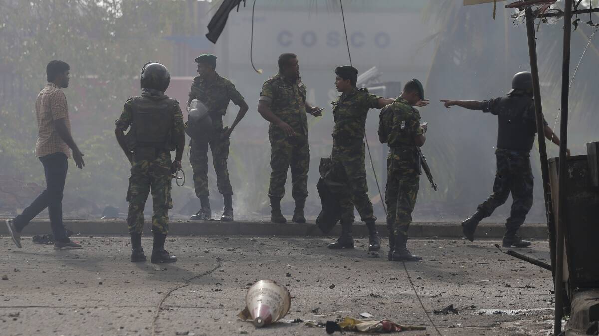 Sri Lankan security forces stand at the site where a vehicle parked near St. Anthony's shrine exploded in Colombo, Sri Lanka. Photo: AP