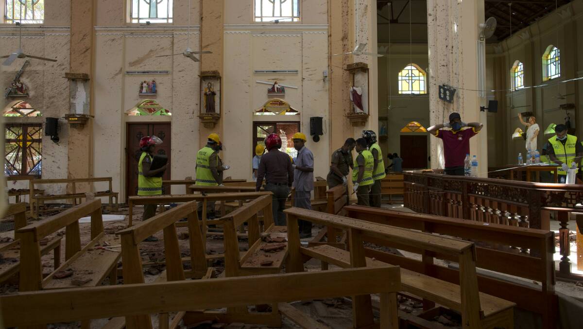 Investigators at the scene of a suicide bombing at St. Sebastian Church in Negombo, Sri Lanka. Photo: Gemunu Amarasinghe/AP