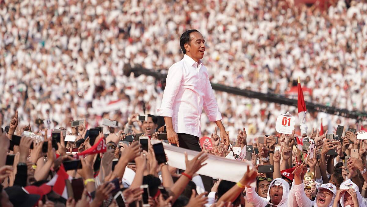 Joko Widodo, Indonesia's president, walks on stage as his supporters cheer during a campaign rally in Jakarta. Picture: Dimas Ardian/Bloomberg