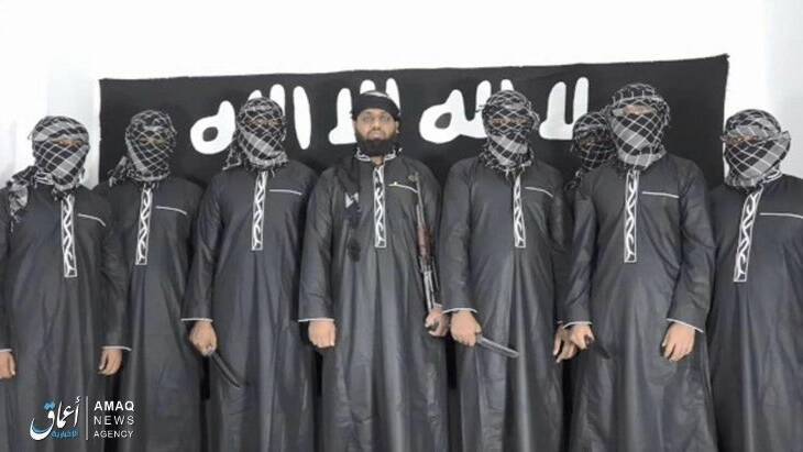 Islamic State has provided an image of what it says were the attackers in Sri Lanka standing before the ISIS flag.