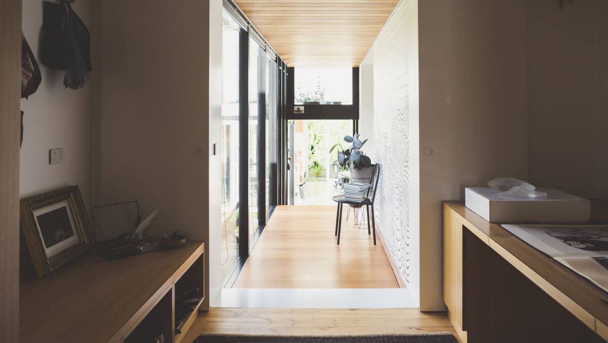 The hallway of the Forrest home leads to the lower-level kitchen Photo: Jamila Toderas