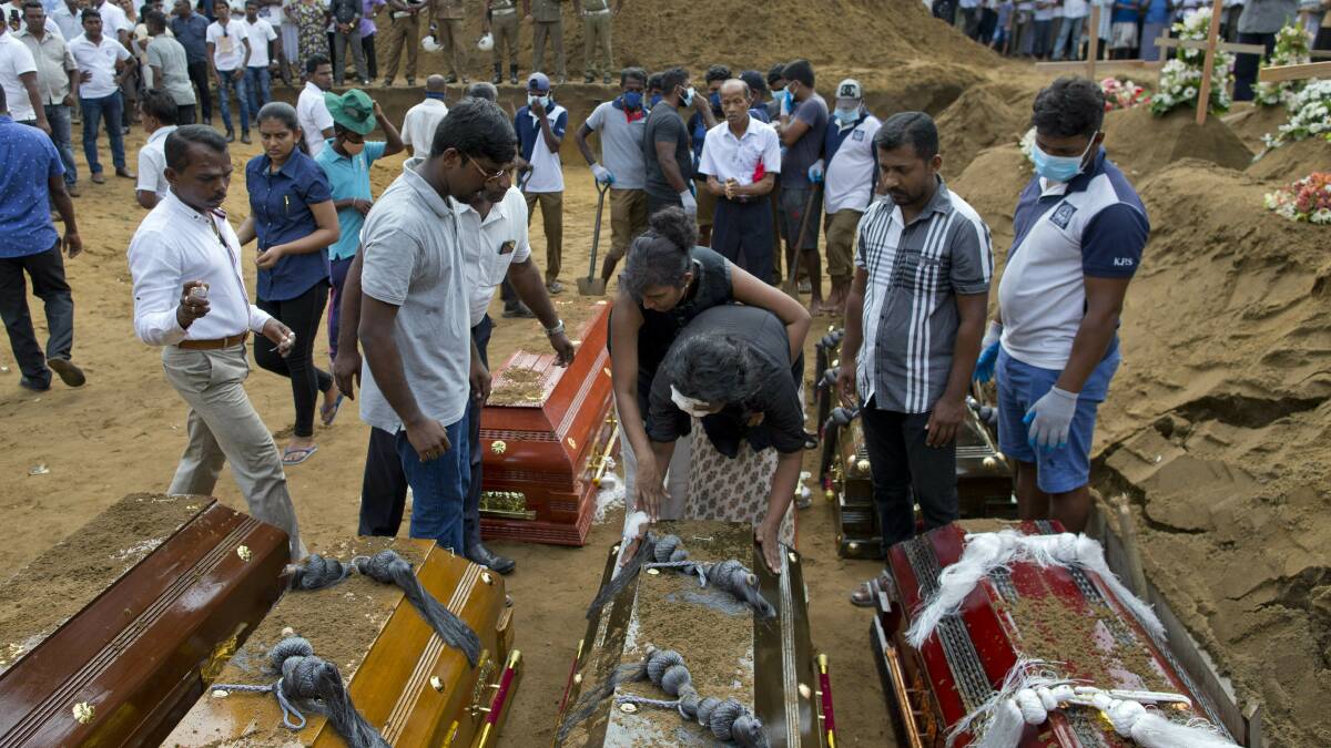 Anusha Kumari, centre bottom, mourns her husband, two children and three siblings, victims of the Easter bomb blasts in Sri Lanka. Picture: Gemunu Amarasinghe