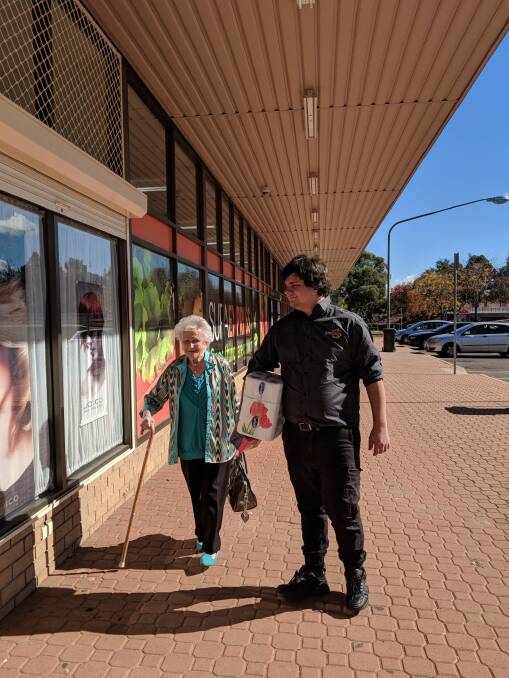 Richardson supermarket customer Nola Nuske, 88, gets help with her groceries from worker Alexander Schenk on Friday. Photo: Megan Doherty