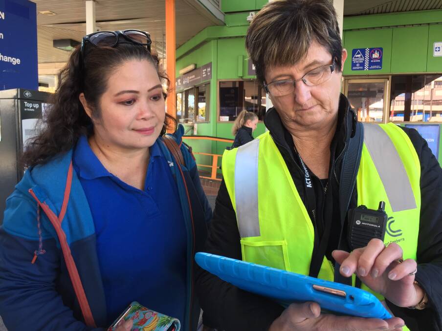 Customer services assistant Helen Symons (right) answers a question from Erna Fider at Woden bus station. Photo: Steve Evans