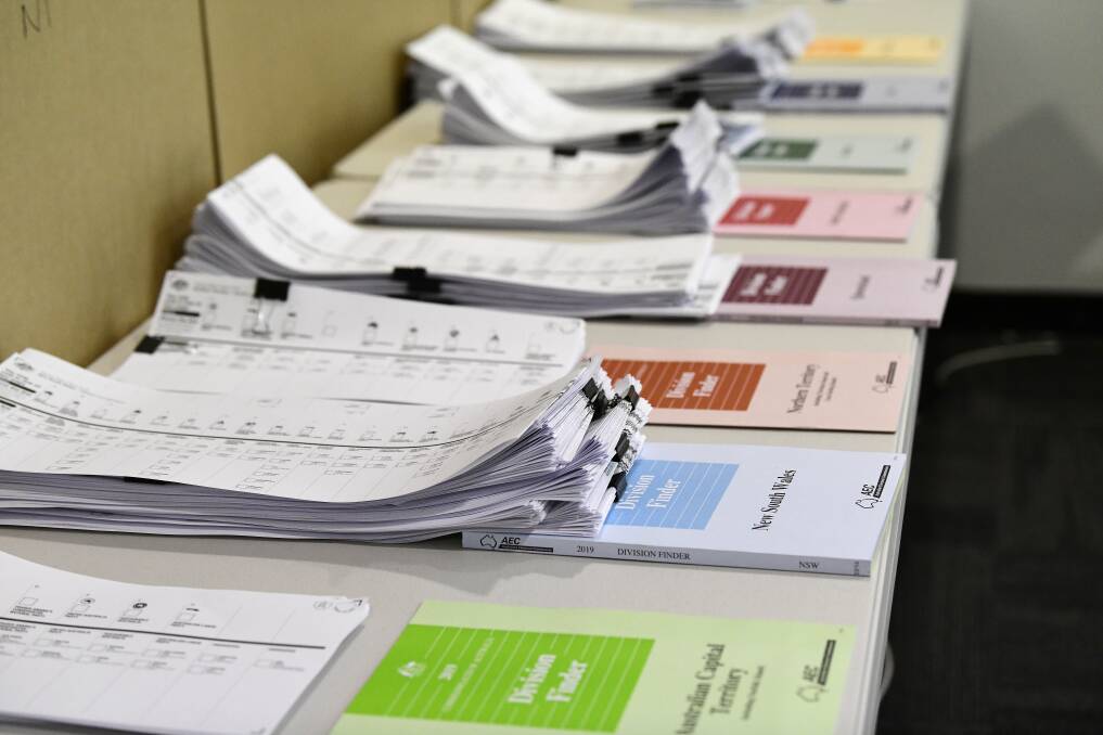 Australian Electoral Commission Division Finder books are seen at a pre-polling booth. Picture: AAP