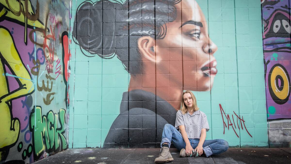 Graffiti artist Faith Kerehona paints a wall at the legal graffiti practice site lat the skate park in Civic.