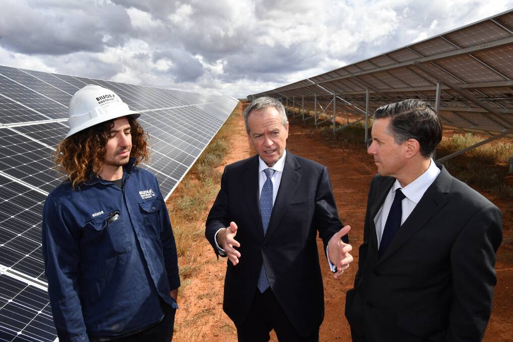 Opposition Leader Bill Shorten and Shadow Minister for Climate Change and Energy, Mark Butler talk to Wilson Burns at the Southern Sustainable Electric solar farm in Whyalla, South Australia. Picture: AAP