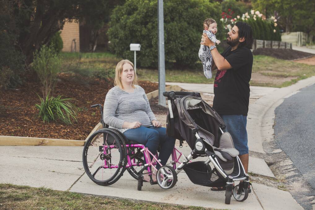 Franciine Rowland-Mahmoud, her husband Mahmoud Abouhamza and their baby Ali, nearly three months old. Francine's wheelchair was modified by TADACT so she could push the baby's pram. Picture: Jamila Toderas