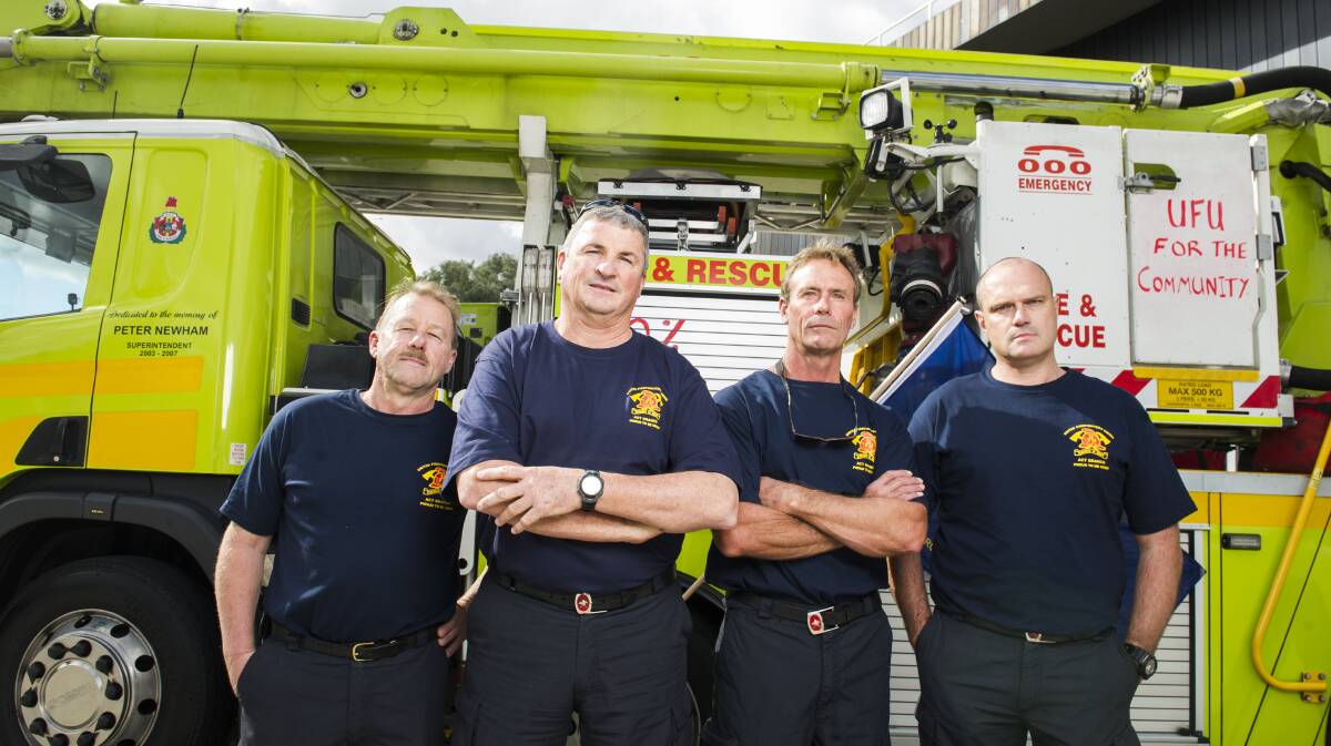 Senior firefighter Warren Hansen, commander Todd Bourne, senior firefighter John Hay and commander Craig Perks are members of the United Firefighters Union, which is taking industrial action in pursuit of a new enterprise bargaining agreement. Picture: Dion Georgopoulos