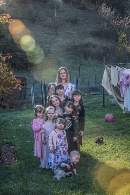 Claire Hooker with (from front) Michael, 1, Martina, 2, Rose, 4, Catherine, 6, Elizabeth, 6, Abigail, 7, Franchesca, 8, Charlotte, 9 and Georgina, 10. Picture: Karleen Minney.