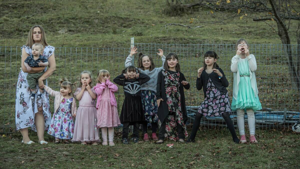 Claire Hooker with her nine children at home at Captain's Flat enjoying a moment of silliness. Picture: Karleen Minney.