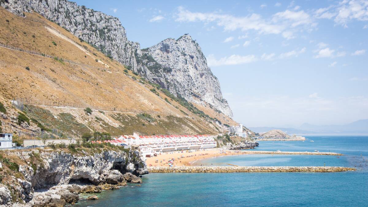 One of the territory's beaches with the Rock of Gibraltar rising up above it. Picture: Michael Turtle