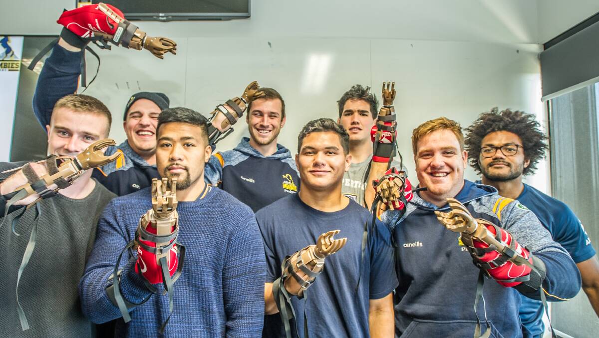 The Brumbies participating in a "Helping Hands" project, making prosthetic hands, which will be sent to children who have lost limbs due to landmines in Cambodia. Picture: Karleen Minney