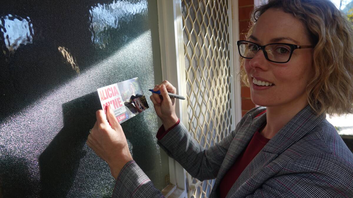 Nobody home. Labor's Alicia Payne leaves a leaflet. Picture: Steve Evans