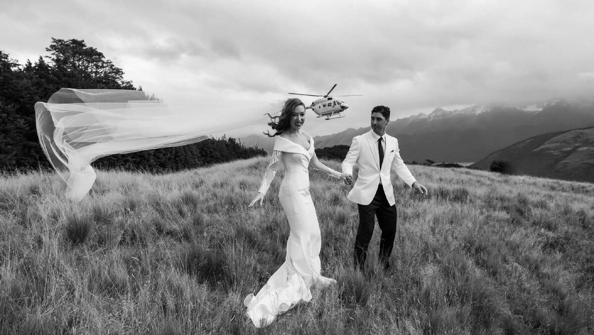 Kristen Henry and Iain Davidson flew their wedding party by helicopter up to a mountain setting for their photographs. Picture: Kate Drennan Photography