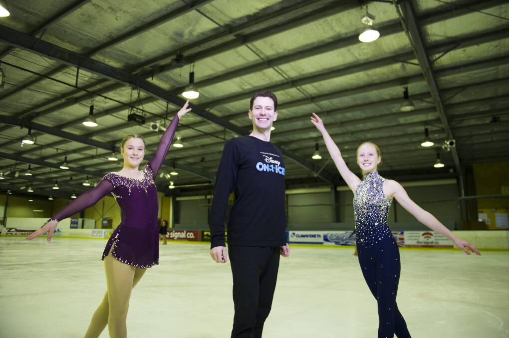 Disney On Ice's Grant Marron with locals Millie Raymond, left, and Isabella Van Den Bogaart at the Phillip Ice Skating Centre. Picture: Dion Georgopoulos