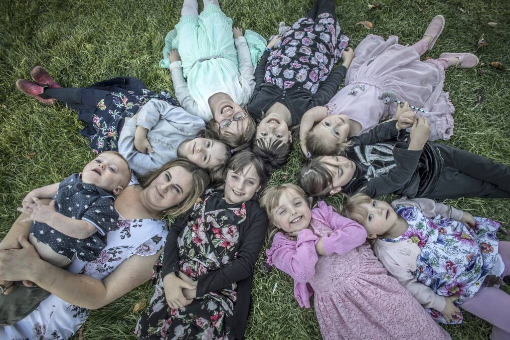 Captains Flat mother Claire Hooker with her children (from front): Michael, 1, Martina, 2, Rose, 4, Catherine, 6, Elizabeth, 6, Abigail, 7, Franchesca, 8, Charlotte, 9, and Georgina, 10. Picture: Karleen Minney