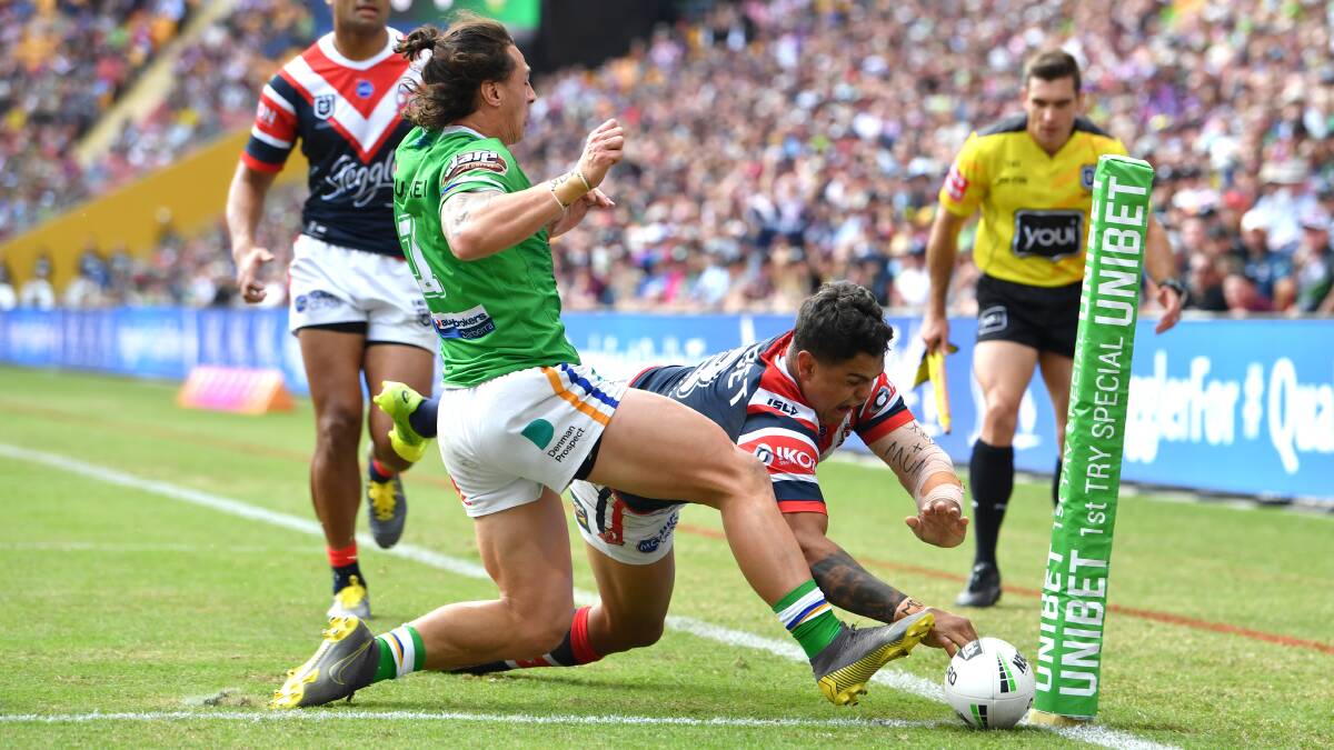 Latrell Mitchell of the Roosters scores a try despite the efforts of Charnze Nicoll-Klokstad. Picture: AAP Image/Darren England