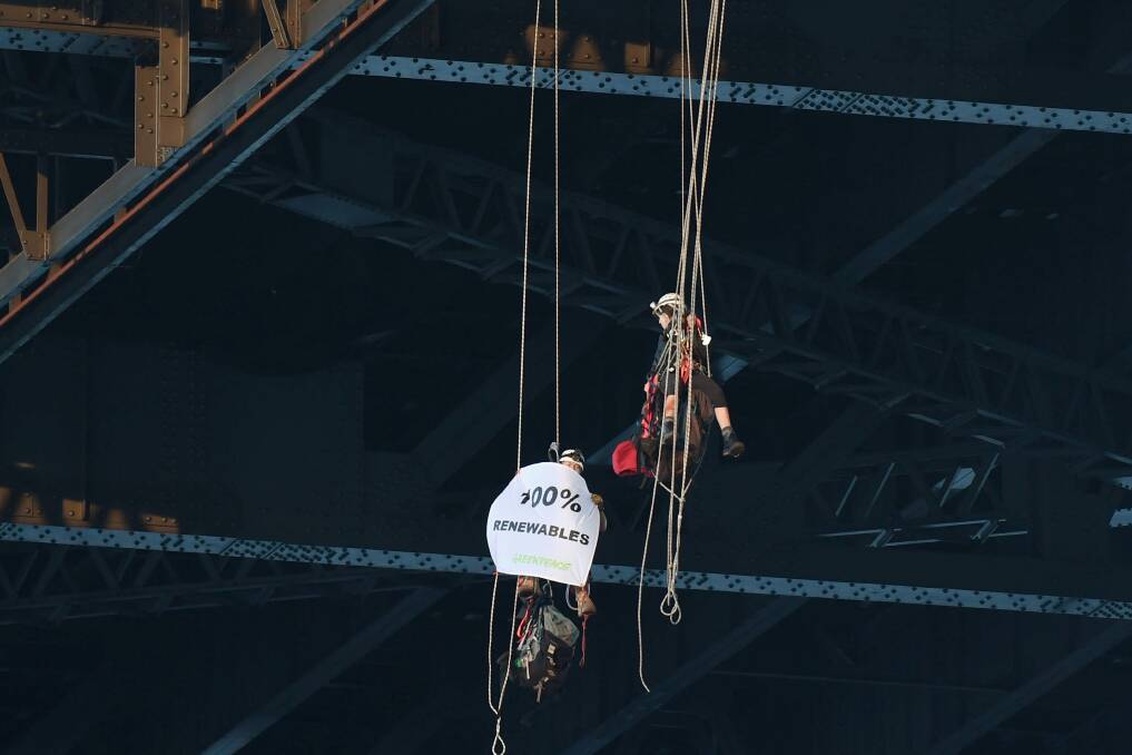Greenpeace protestors hang off the Sydney Harbour Bridge. Picture: Nick Moir