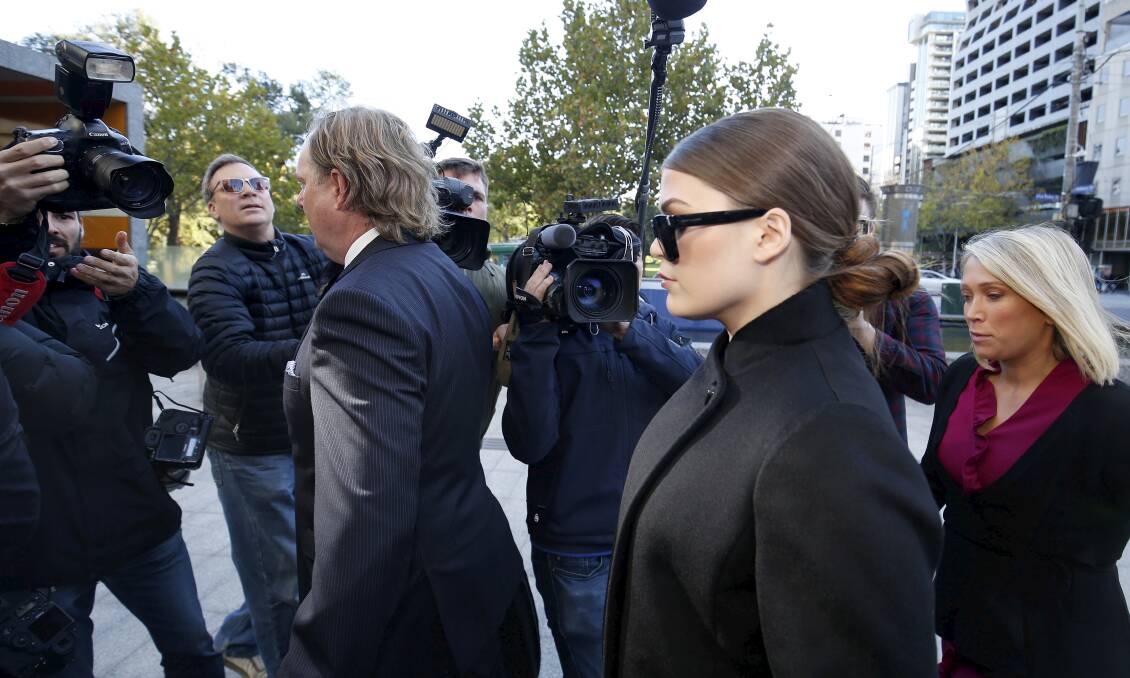 A press pack surrounds Belle Gibson as she makes her way into court. Picture: Darrian Traynor