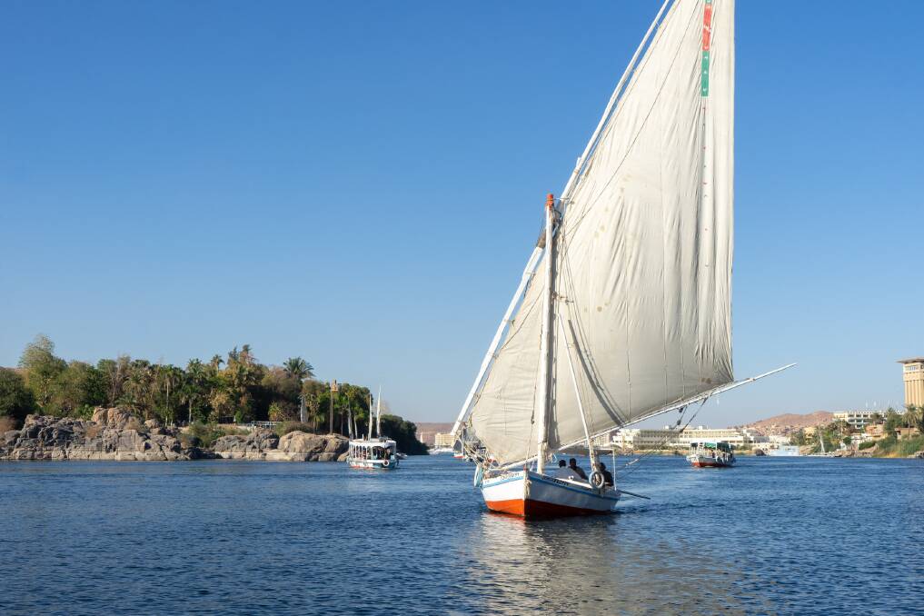 Sailing on a traditional felucca on the Nile at Aswan.