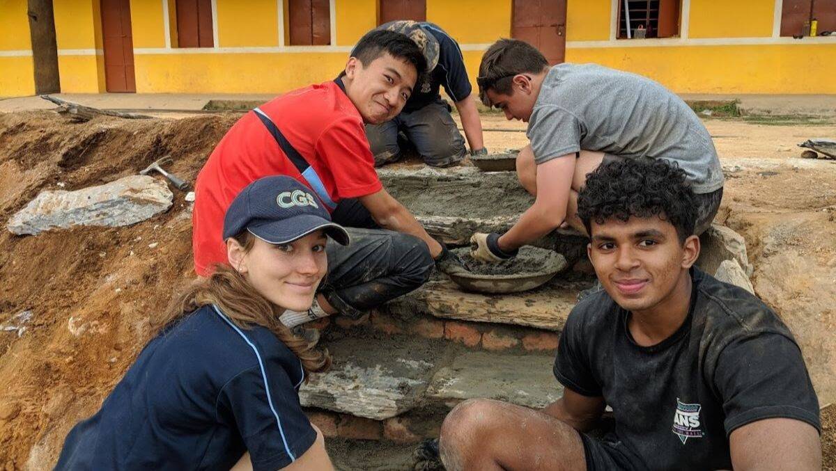 Canberra Grammar School students working in Nepal. Neve Hawkins (front left), Maathu Pranavan (front right) and Alex Wang (back left). Picture: Supplied